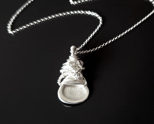 Sterling Silver Sculptural and Wire Wrapped Pendant with coils and texture on a rolo style chain on black background 