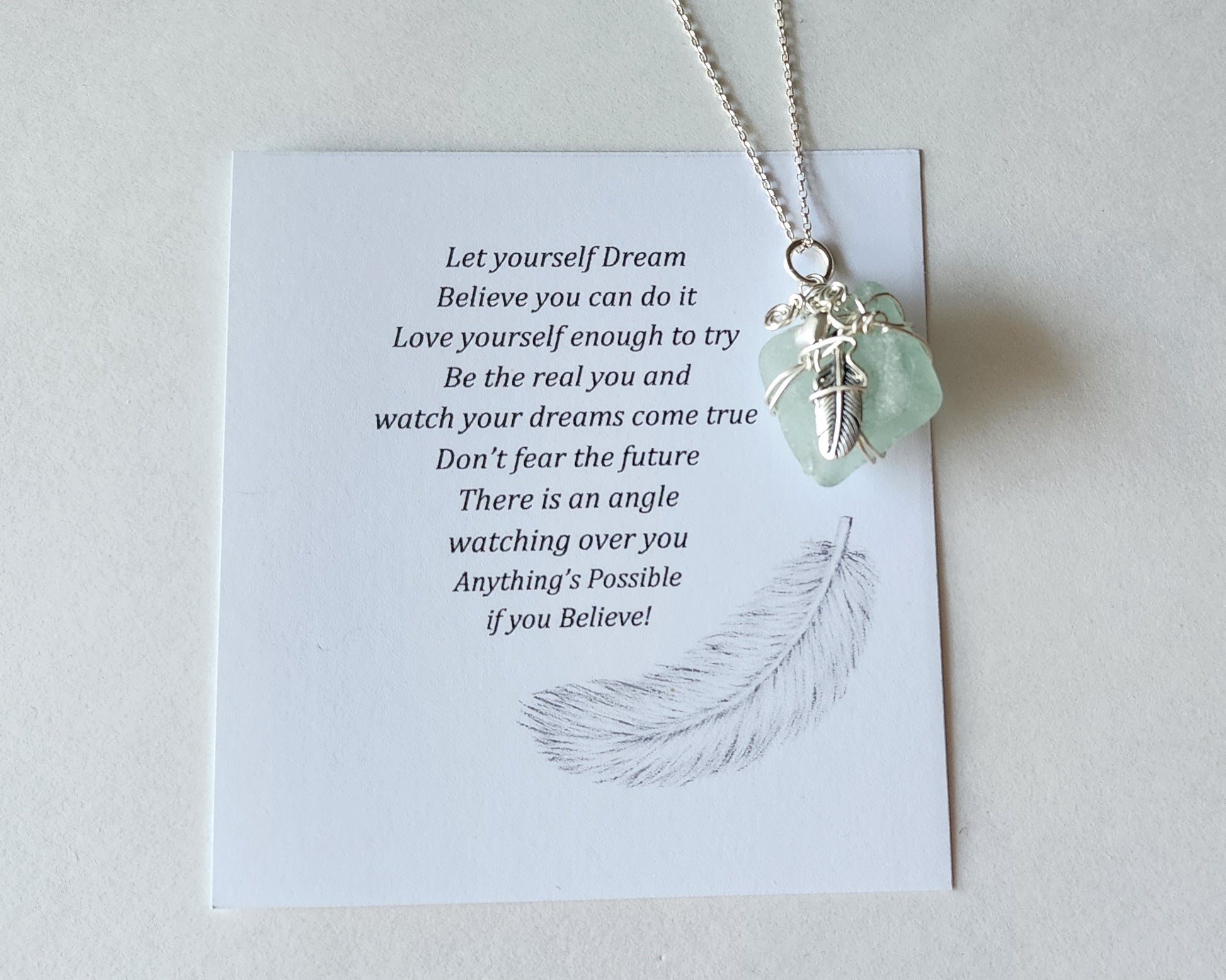 Feather on the Beach Aqua Blue Beach Glass / Freshwater Sea Glass Pendant with Sterling Silver Feather and wire wrapped design. 