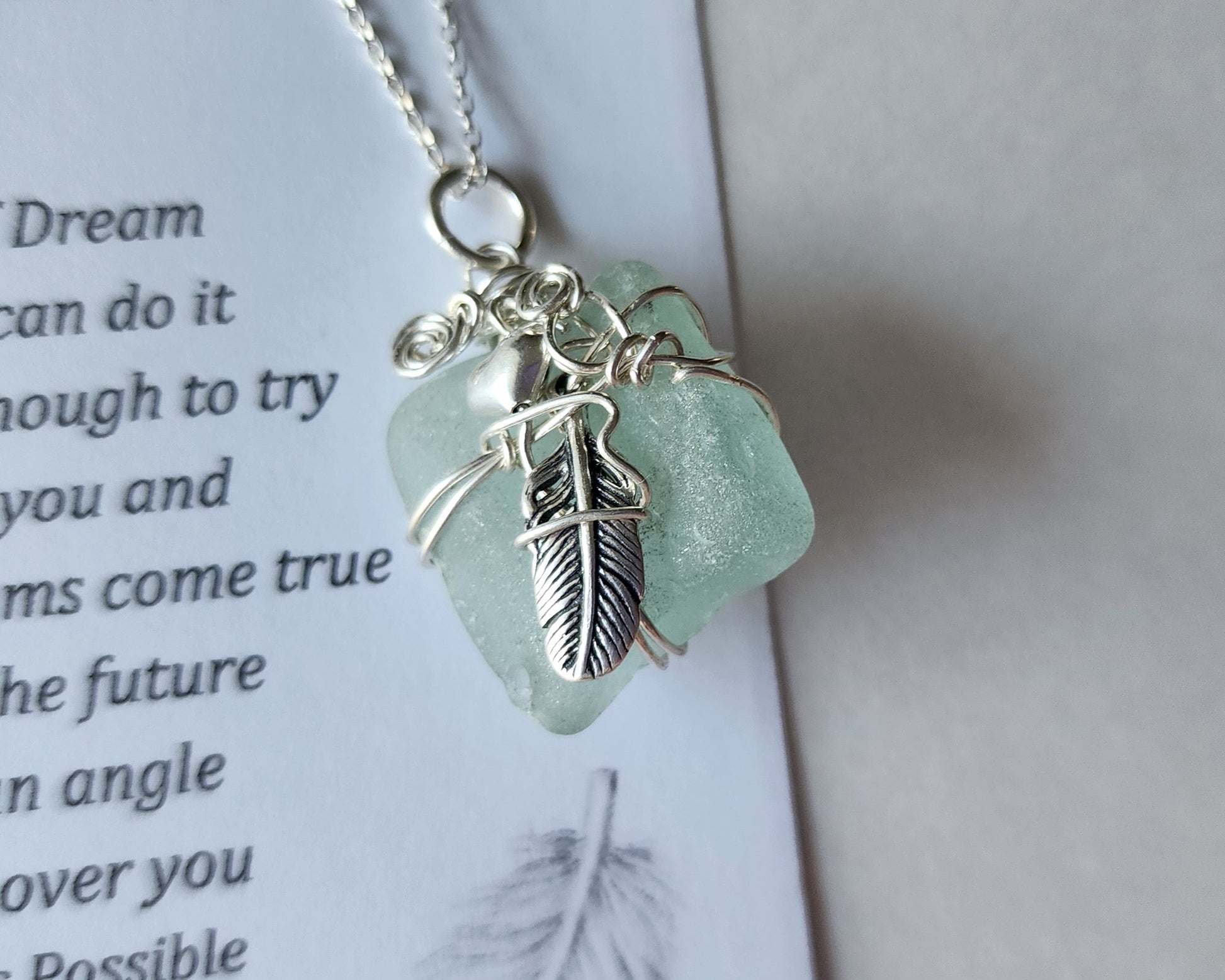 Feather on the Beach Aqua Blue Beach Glass / Freshwater Sea Glass Pendant with Sterling Silver Feather and wire wrapped design. 