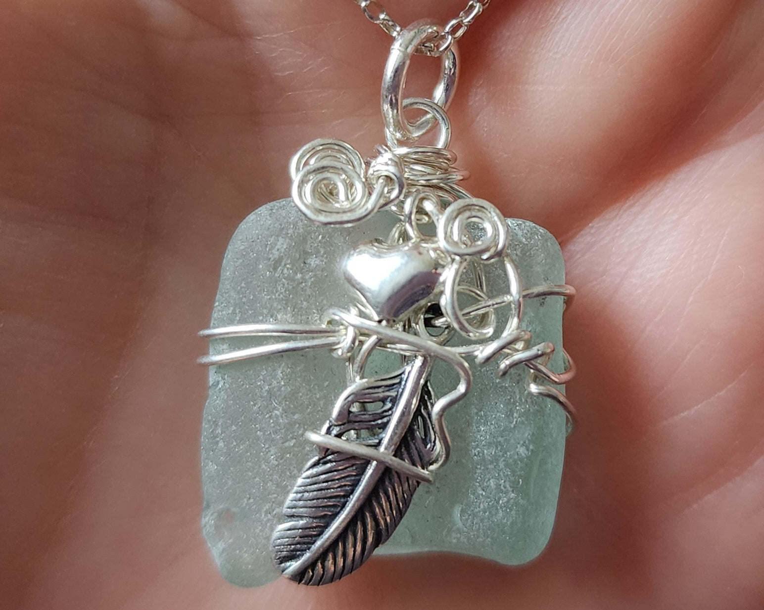 Feather on the Beach Aqua Blue Beach Glass / Freshwater Sea Glass Pendant with Sterling Silver Feather and wire wrapped design. 