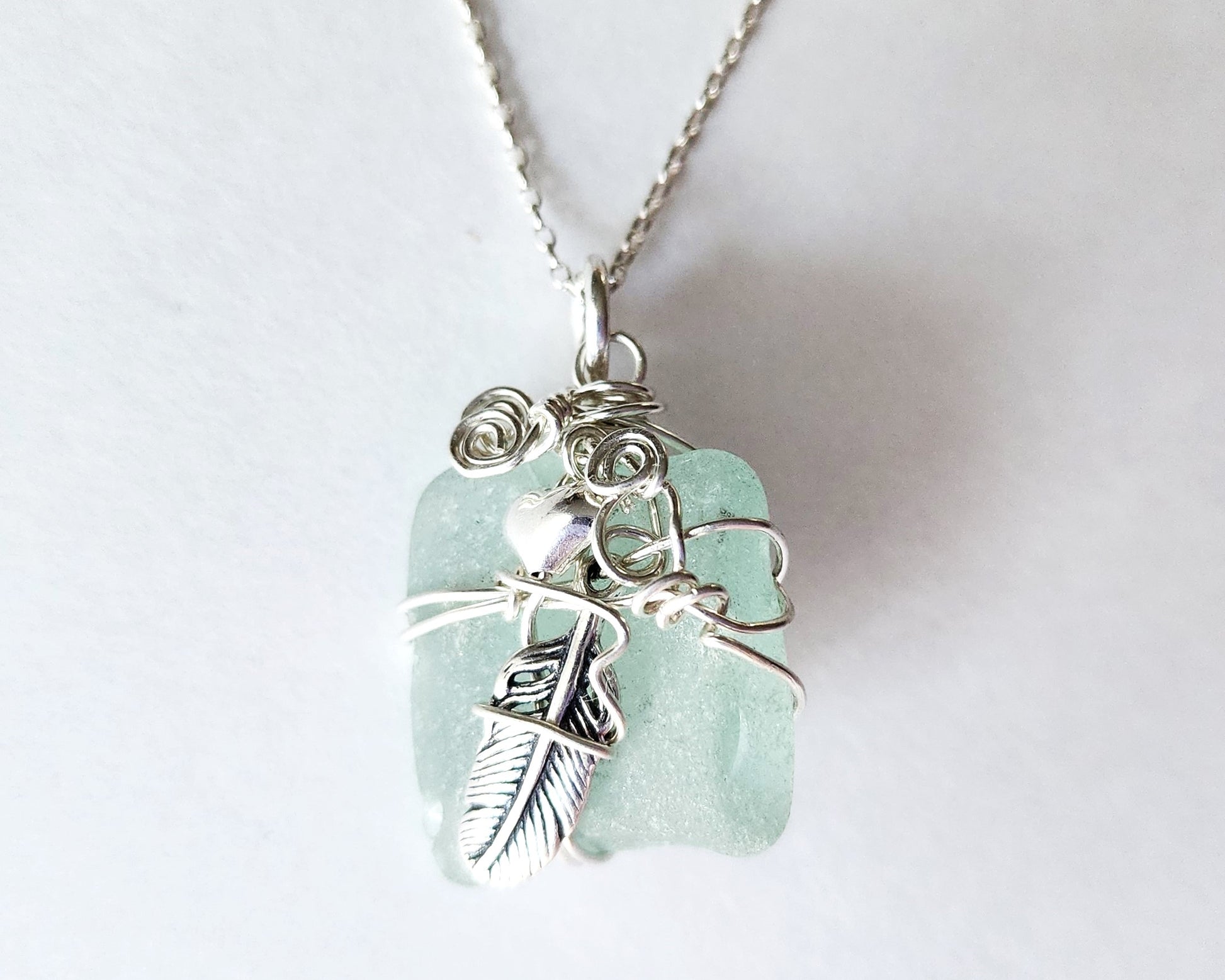 Feather on the Beach Aqua Blue Beach Glass / Freshwater Sea Glass Pendant with Sterling Silver Feather and wire wrapped design. 