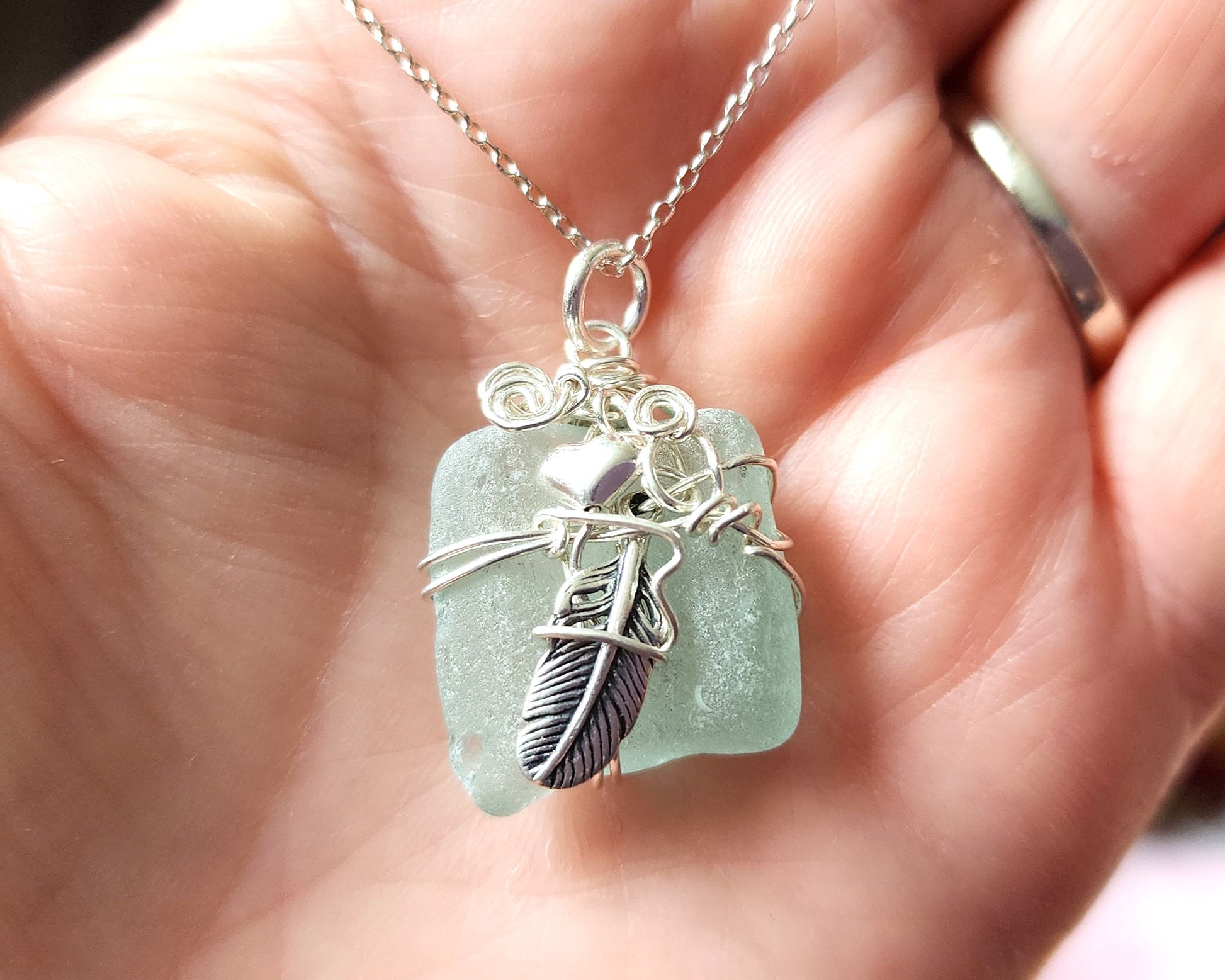 Feather on the Beach Aqua Blue Beach Glass / Freshwater Sea Glass Pendant with Sterling Silver Feather and wire wrapped design. 