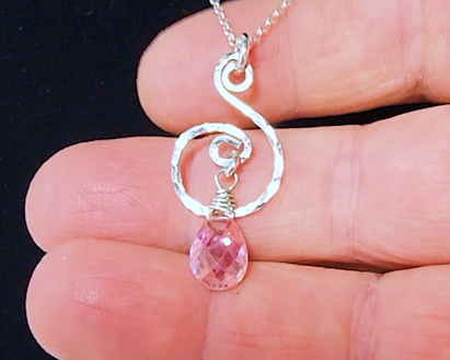 Pink Cubic Zirconia Healing Pendant hand forged design, a brilliant pink Cubic Zirconia dangle on Rolo chain on hand