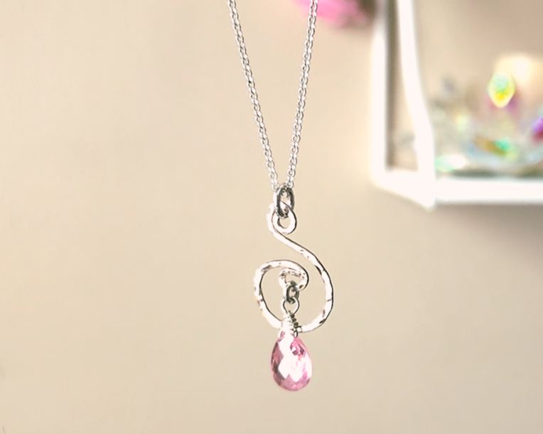 Celtic inspired Sterling Silver pendant with a delicate, lively hand forged design, a brilliant pink Cubic Zirconia dangle on Rolo chain