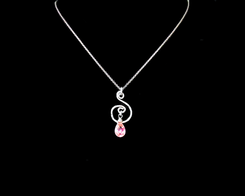 Celtic inspired Sterling Silver pendant with a delicate, lively hand forged design, a brilliant pink Cubic Zirconia dangle on Rolo chain on black background