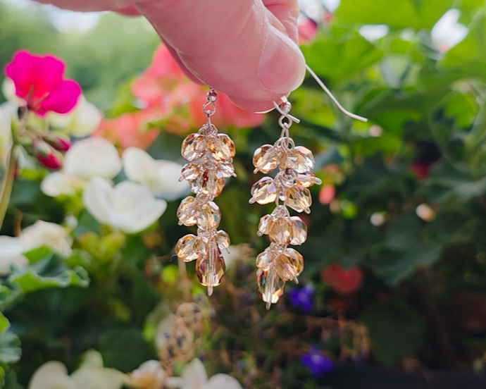 Long sparkly cluster earrings with Champagne Aurora Borealis beads on Sterling Silver with French style earring hooks with Flower Garden background