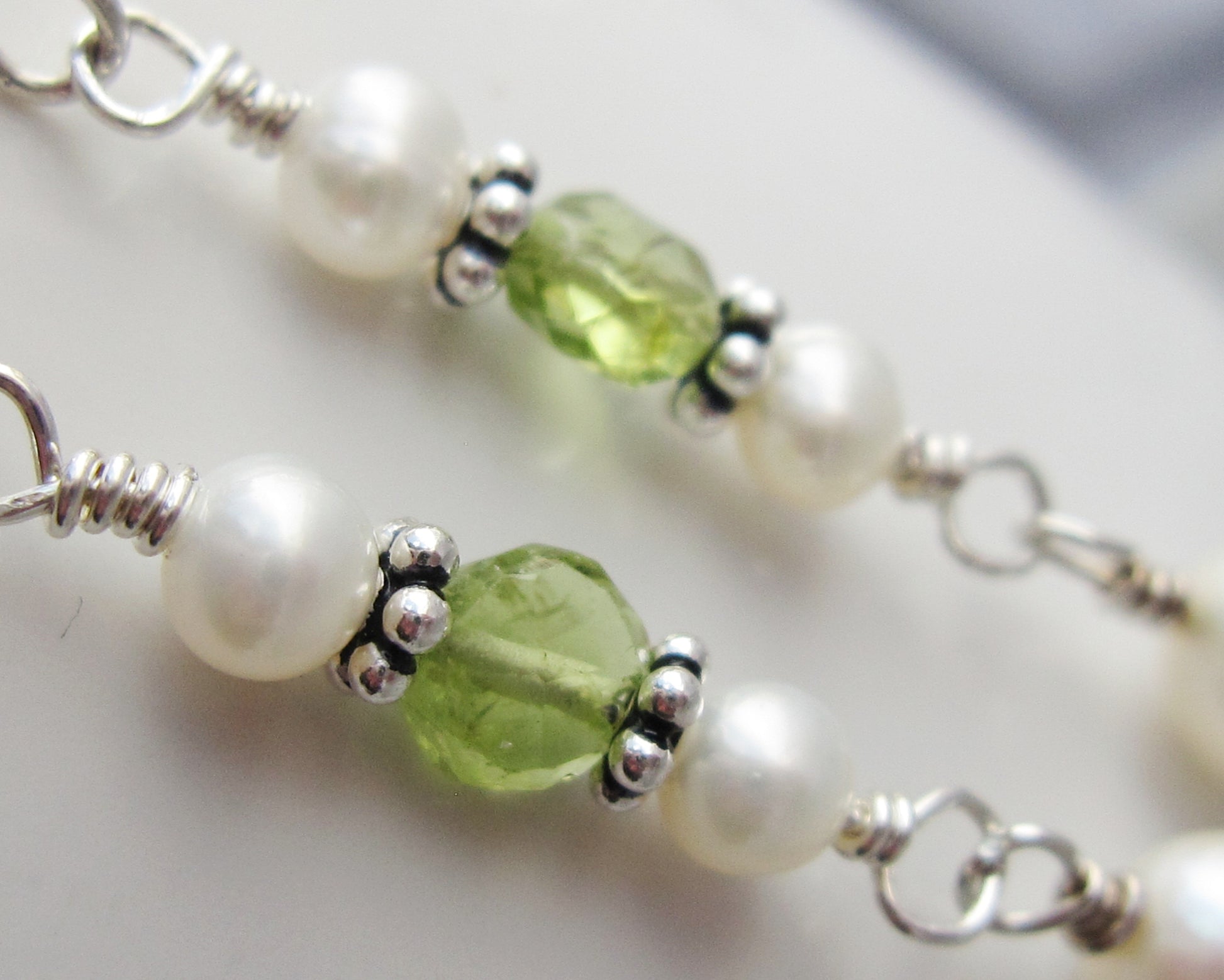 Long Peridot & Freshwater Cultured Pearl Dangle Earrings with Sterling Silver beads displayed on white background 