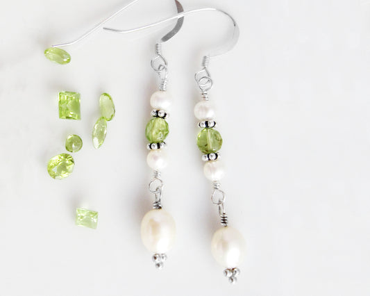 Long Peridot & Freshwater Cultured Pearl Dangle Earrings with Sterling Silver earring hooks displayed on white background with green gemstones 