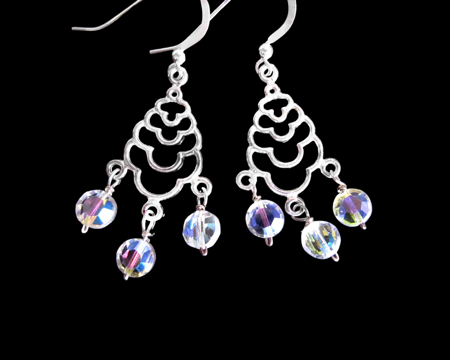 Art Deco Style Long Sterling Silver Chandelier Earrings with three dangly faceted coin shaped Clear AB crystals. The earing are dangling on French earring wires.