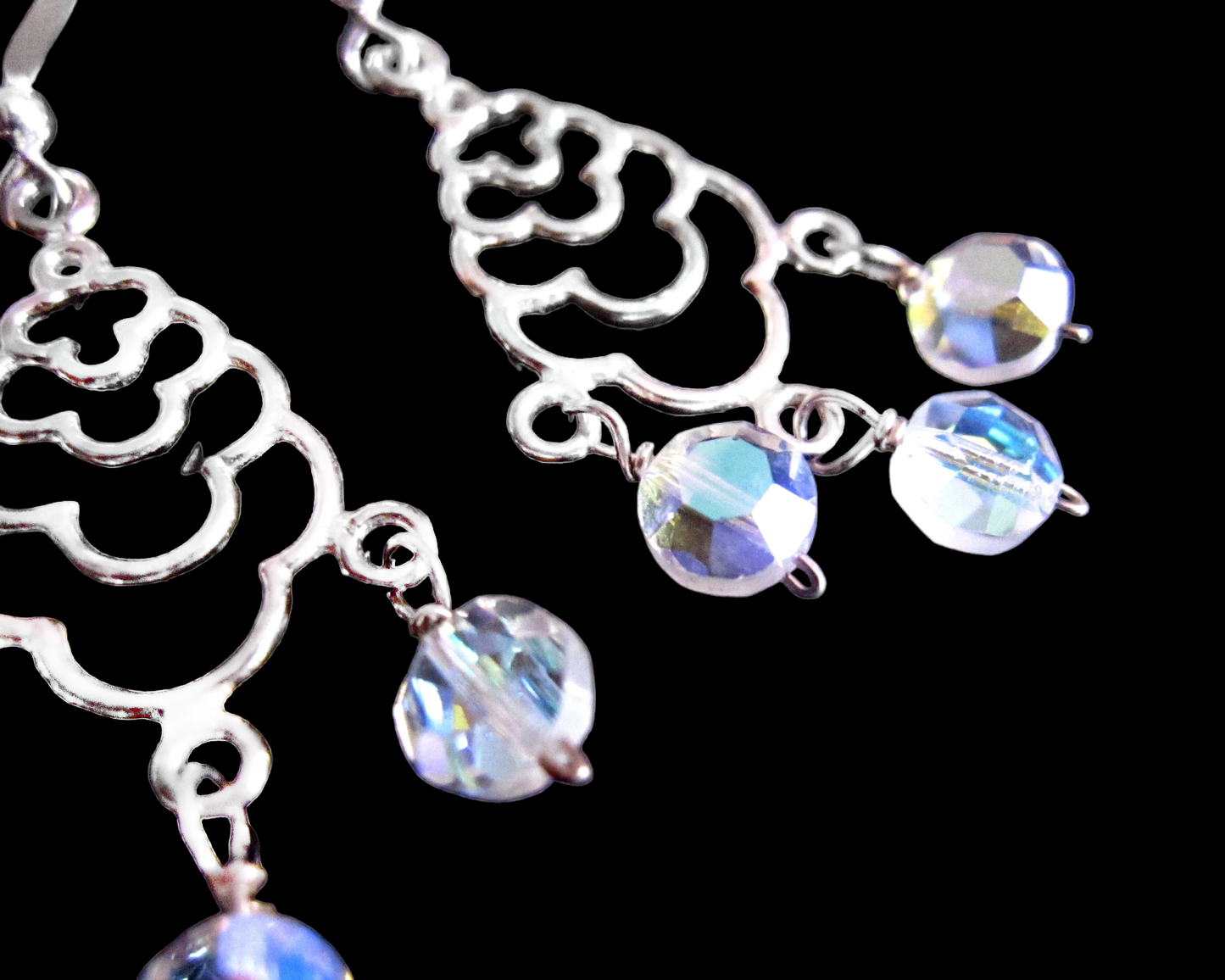Art Deco Style Long Sterling Silver Chandelier Earrings with three dangly faceted coin shaped Clear AB crystals. The earing are dangling on French earring wires.