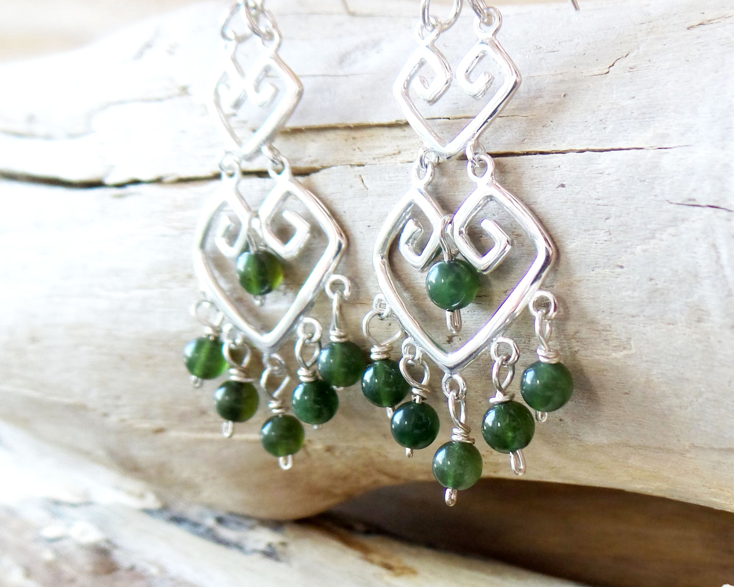 Long Grecian Style Jade Chandelier Earrings made with solid Sterling Silver and Green Jade dangles with wood background. 