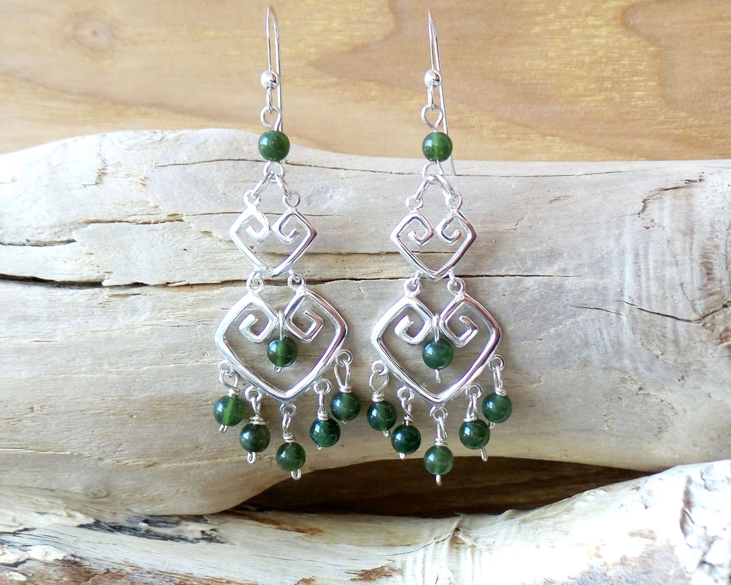Long Grecian Style Jade Chandelier Earrings made with solid Sterling Silver and Green Jade dangles with wood background. 