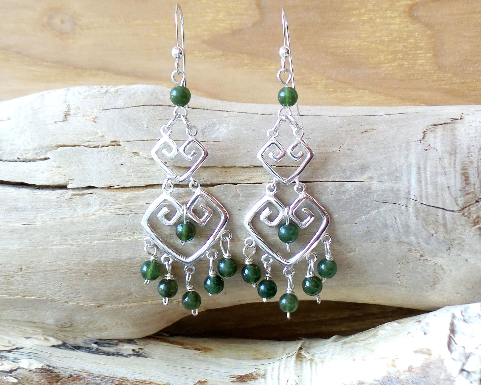 Long Grecian Style Jade Chandelier Earrings made with solid Sterling Silver and Green Jade dangles with wood background. 