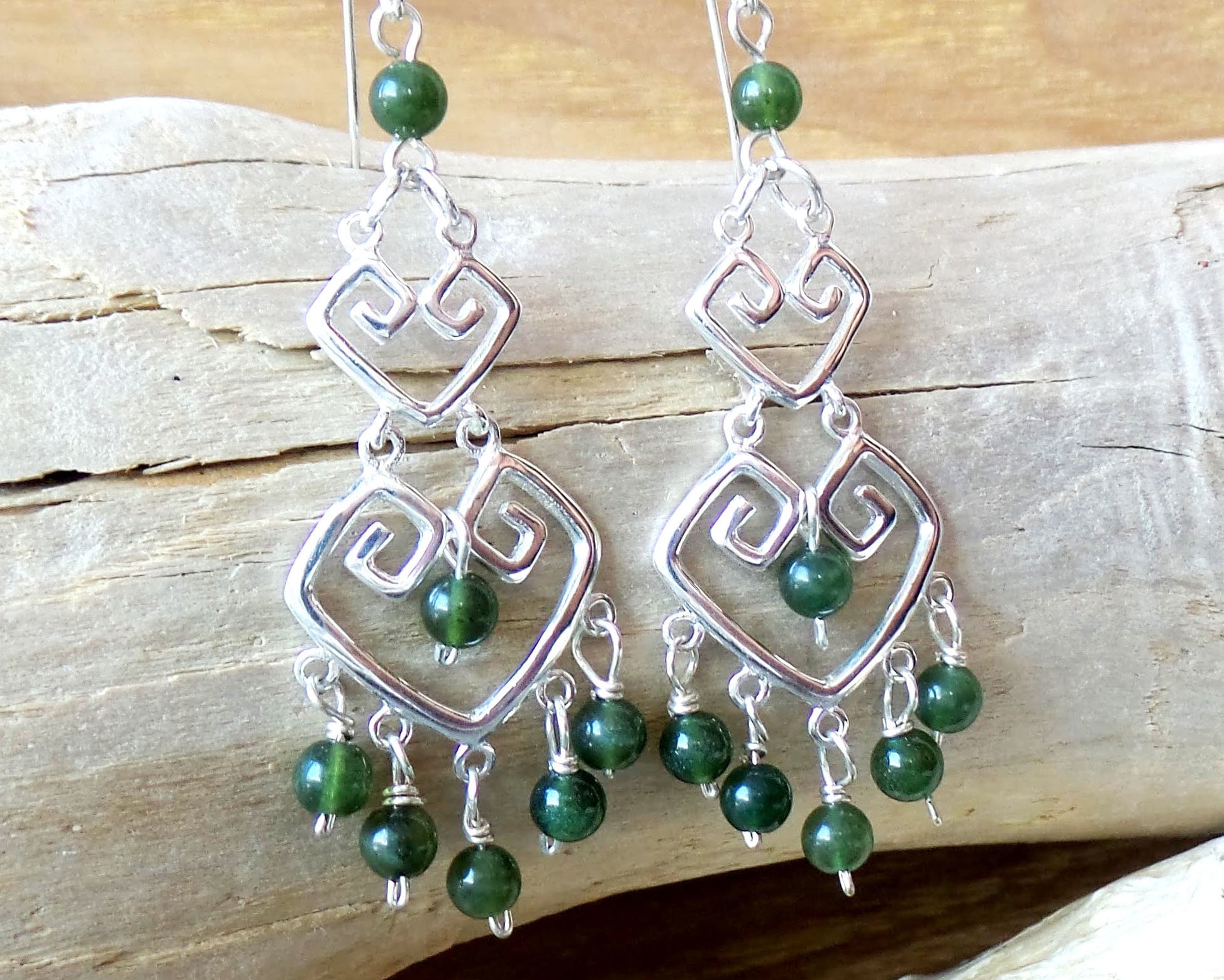 Long Grecian Style Jade Chandelier Earrings made with solid Sterling Silver and Green Jade dangles with wood background. 
