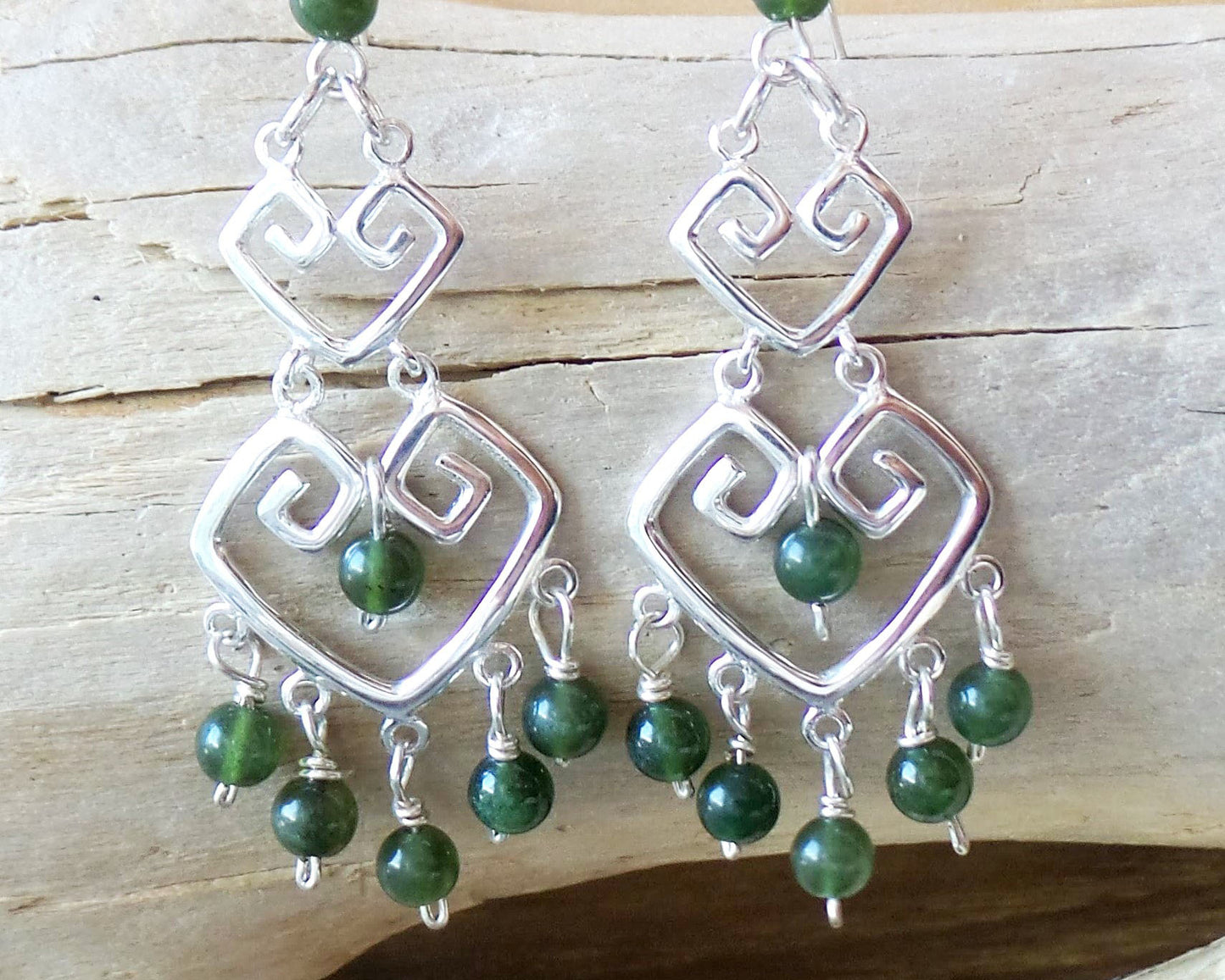 Long Grecian Style Jade Chandelier Earrings made with solid Sterling Silver and Green Jade dangles with wood background. 