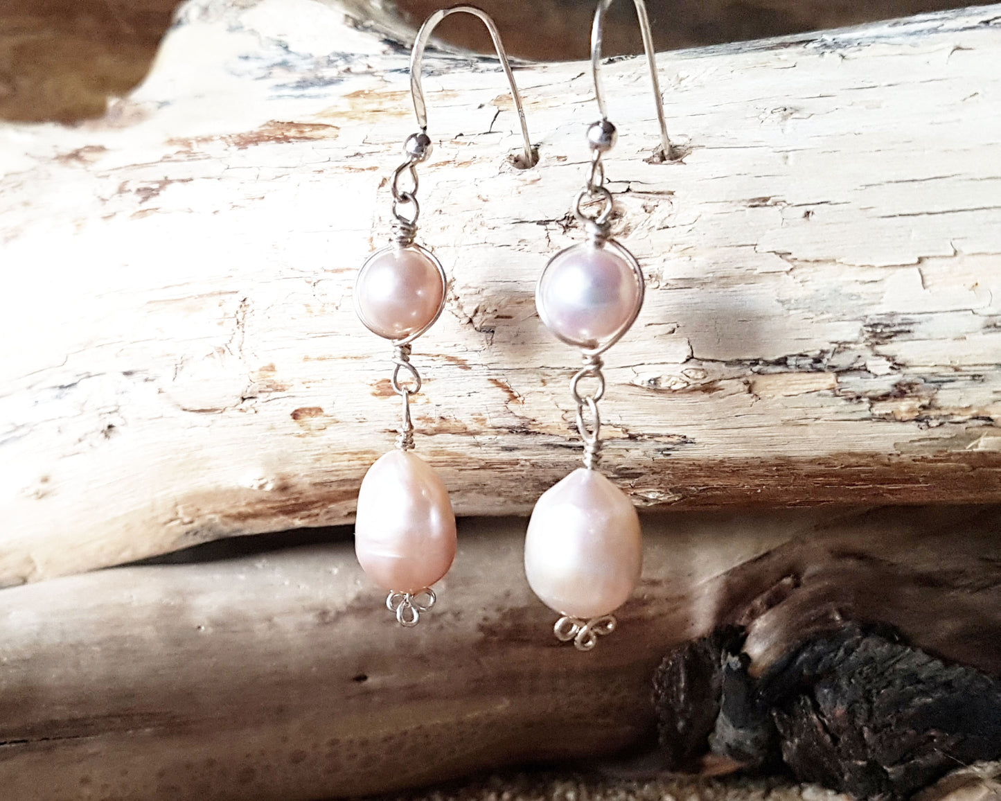 Long Celtic Pale Pink Freshwater Cultured Pearl Dangle Earrings with Sterling Silver trinity know detail on French style earring hooks on wood background 