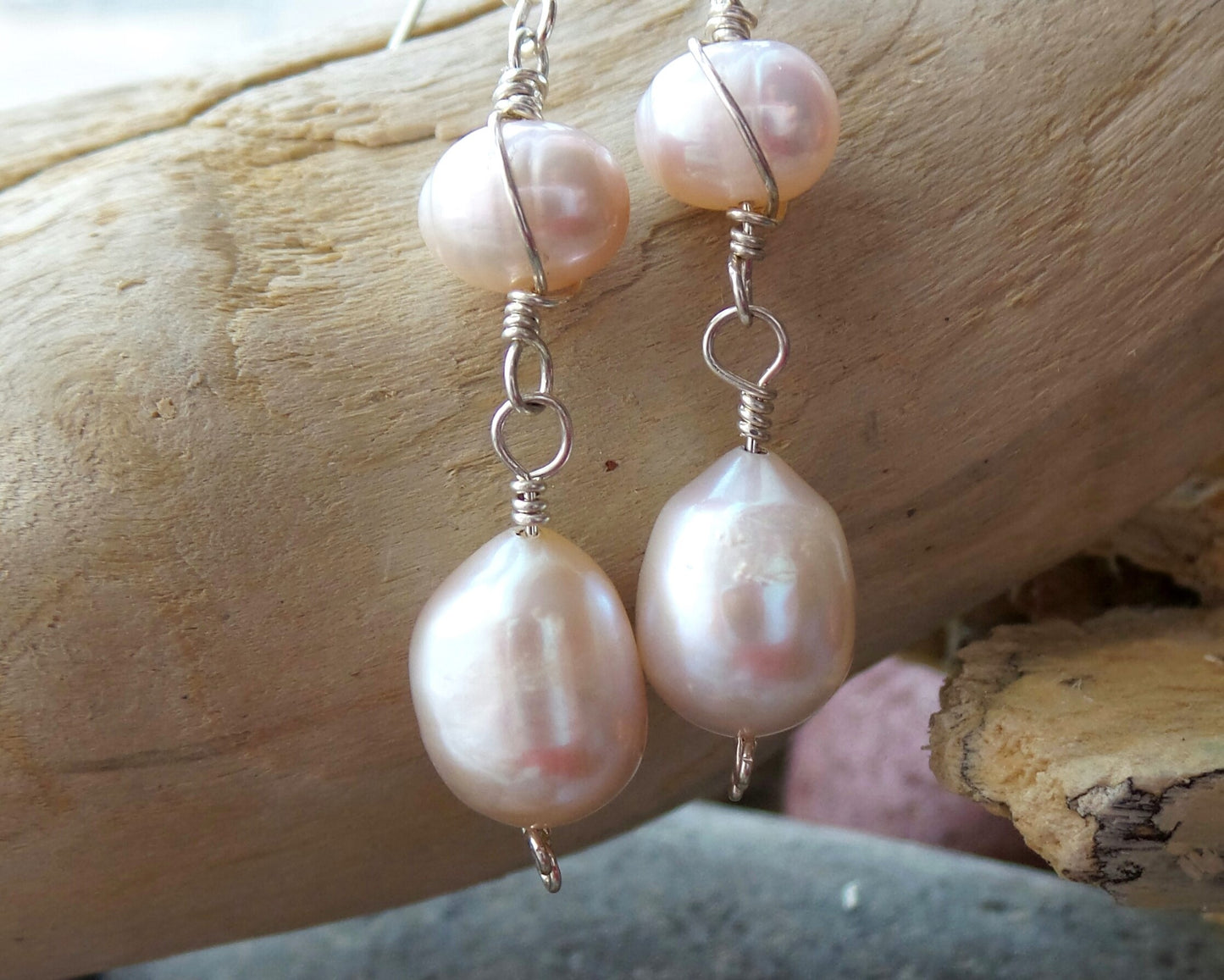 Long Celtic Pale Pink Freshwater Cultured Pearl Dangle Earrings with Sterling Silver trinity know detail on French style earring hooks on wood background 