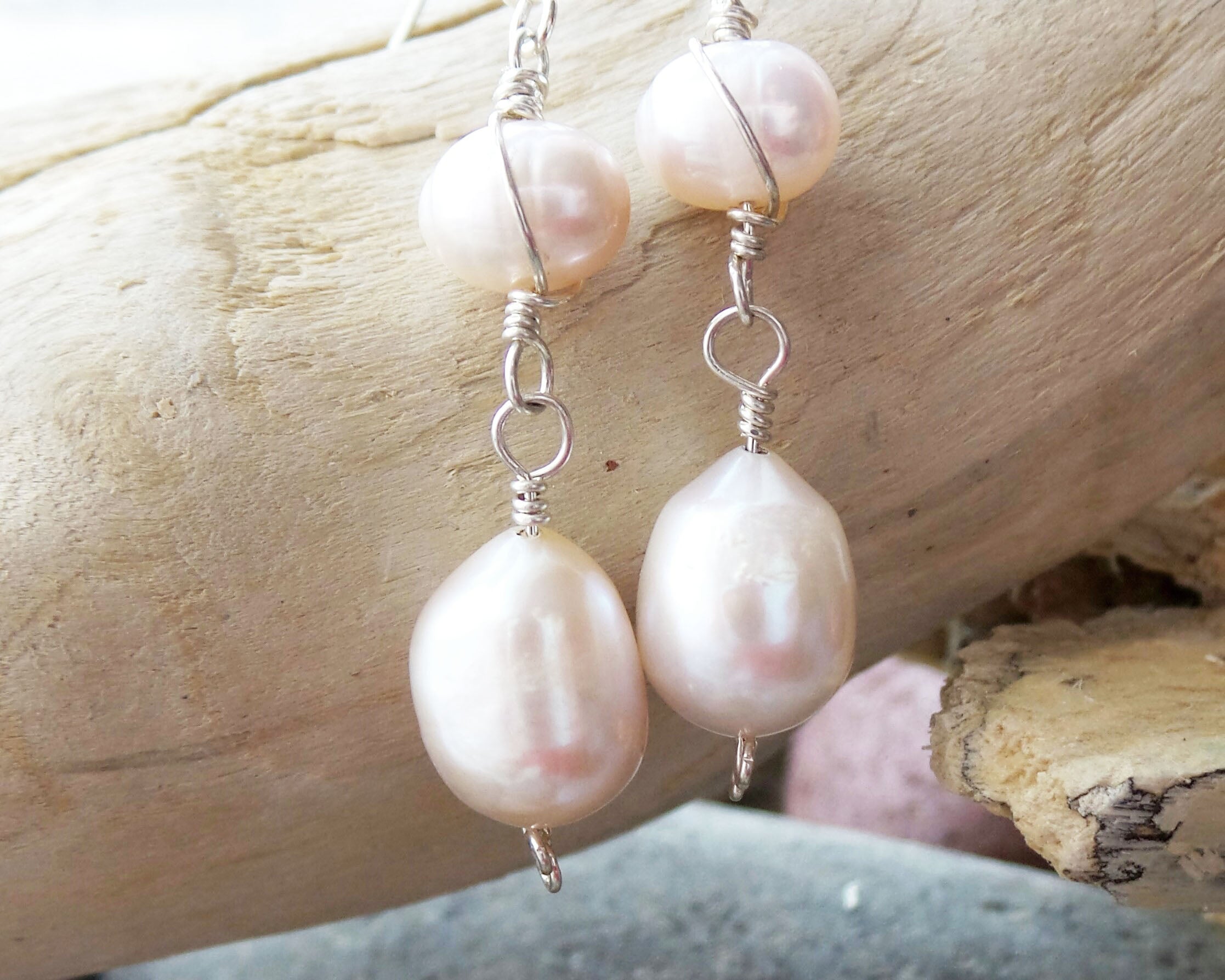 Long Celtic Pale Pink Freshwater Cultured Pearl Dangle Earrings with Sterling Silver trinity know detail on French style earring hooks on wood background 