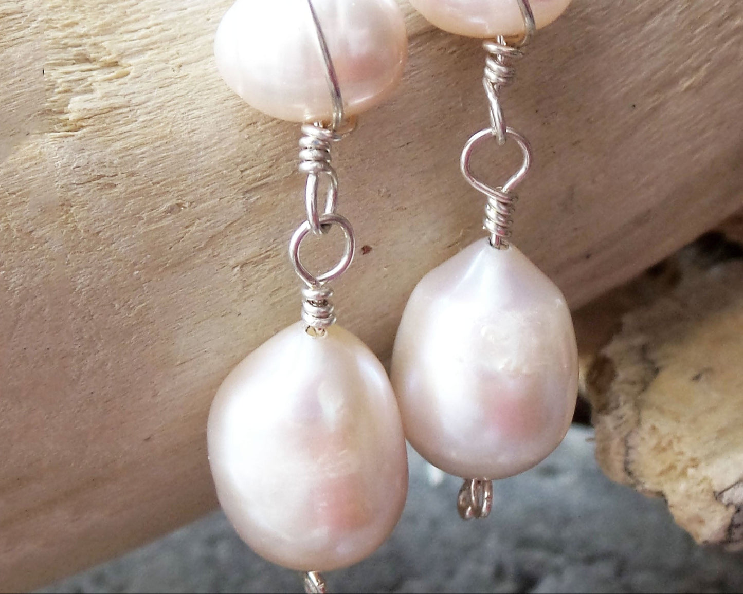 Long Celtic Pale Pink Freshwater Cultured Pearl Dangle Earrings with Sterling Silver trinity know detail on French style earring hooks on wood background 