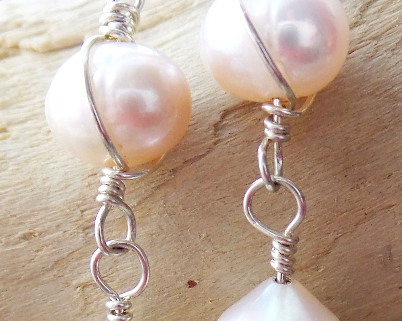 Long Celtic Pale Pink Freshwater Cultured Pearl Dangle Earrings with Sterling Silver trinity know detail on French style earring hooks on wood background 