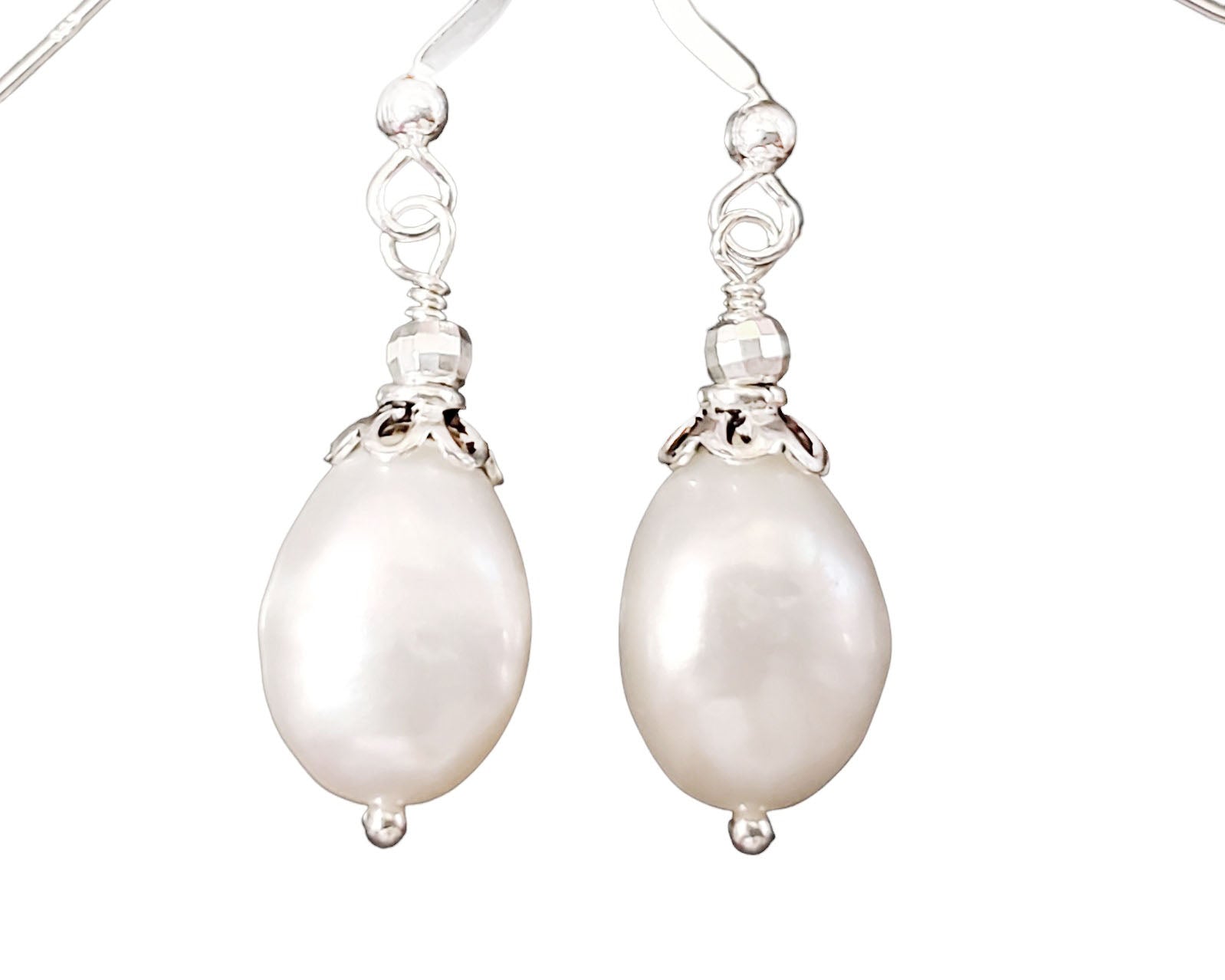 Large White Baroque Pearl Dangle Earrings with decorative silver beads and French earring hooks on white background