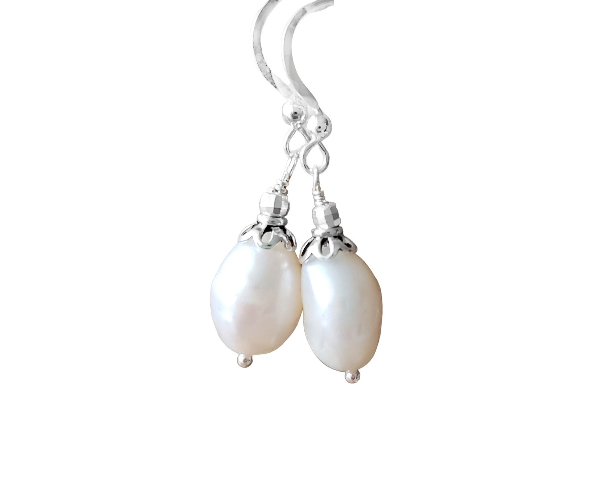 Large White Baroque Pearl Dangle Earrings with decorative silver beads and French earring hooks on white background