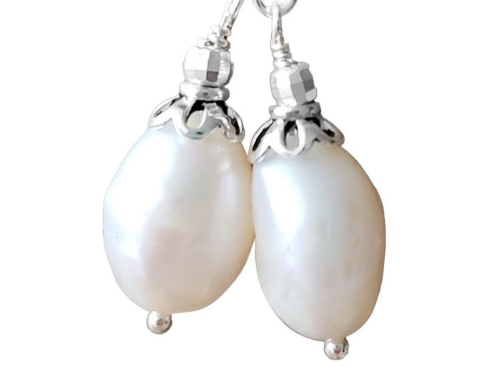 Large White Baroque Pearl Dangle Earrings with decorative silver beads and French earring hooks on white background