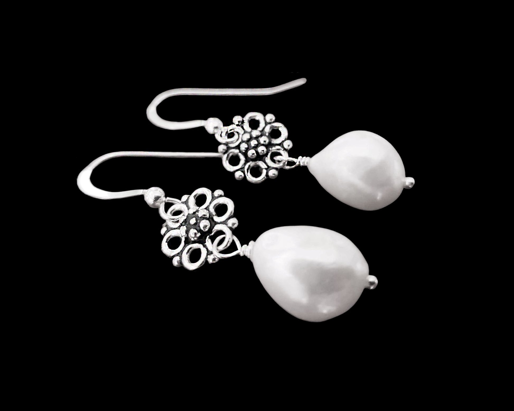 Large White Baroque Pearl Earrings wire wrapped to two decorative, antiqued Sterling Silver floral design pendants.