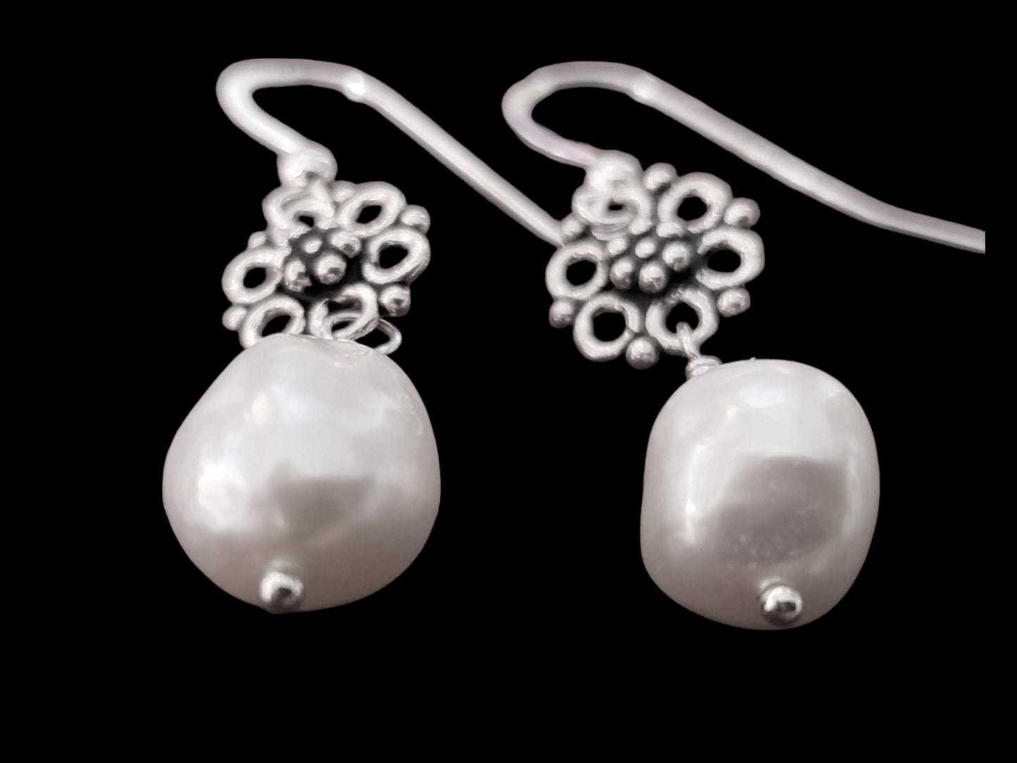 Large White Baroque Pearl Earrings wire wrapped to two decorative, antiqued Sterling Silver floral design pendants.