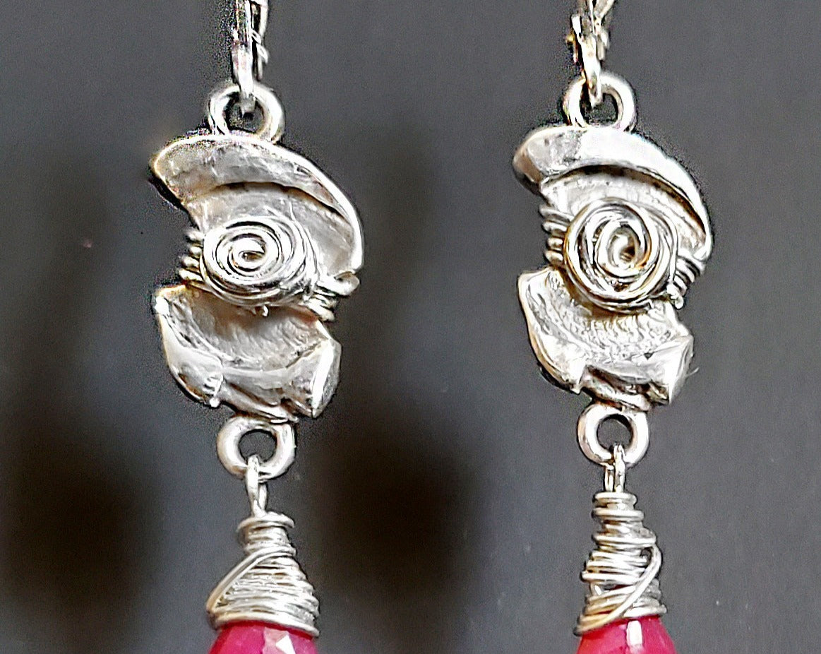 Celtic Style Ruby and Sterling Silver Long Dangle Earrings with Celtic Desing and Drop shaped faceted Ruby stones. 