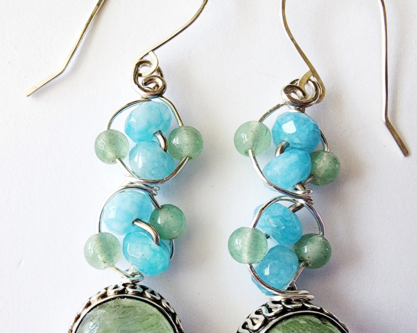 Long Dangle Earrings with large oval shaped Aventurine stones (soft green color) with a long design with blue Quartz and Aventurine beads and Sterling Silver. On French style earring hooks. 