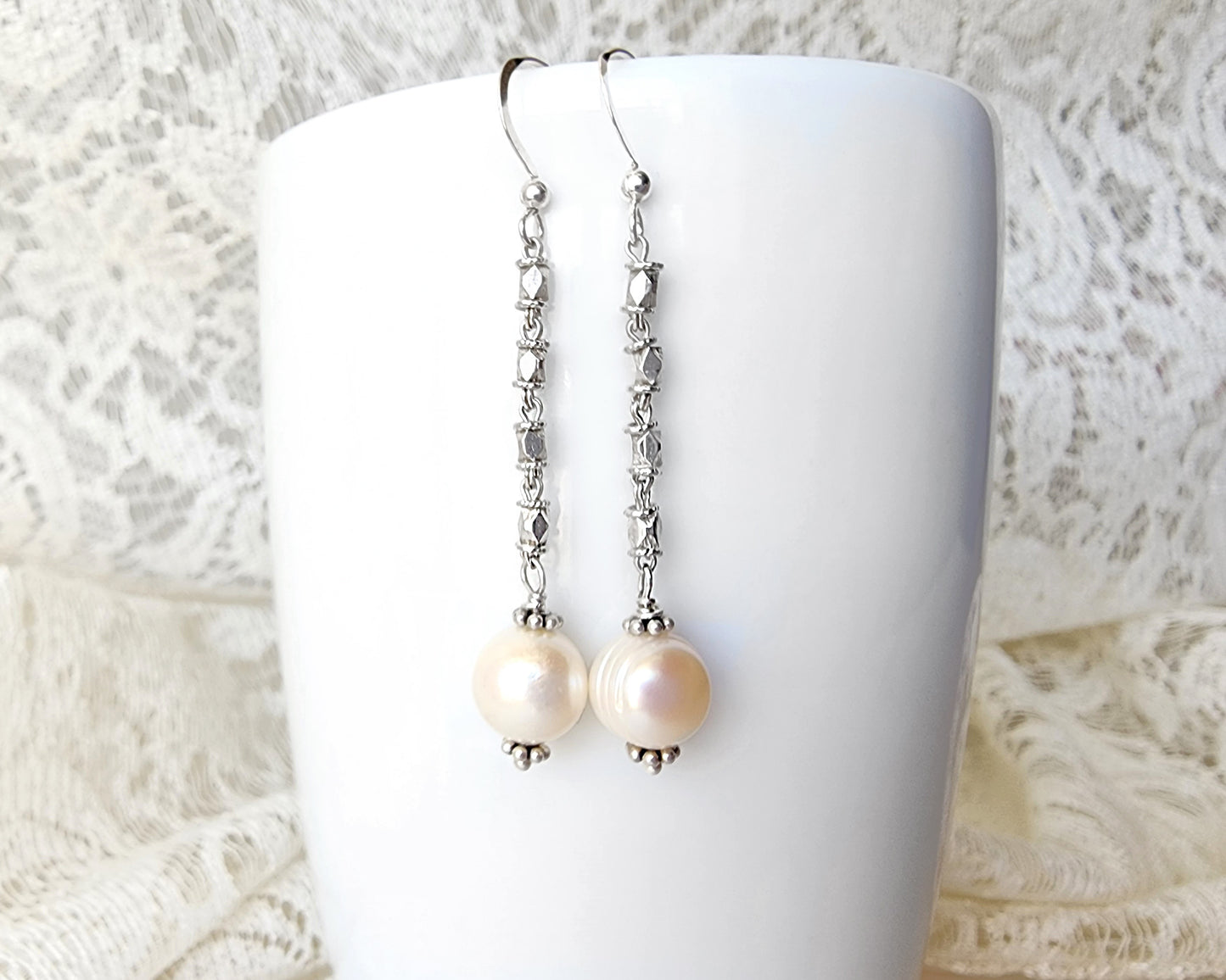 Long Art Deco Style Pearl Drop Earrings, Sterling Silver Decorative Chain with round white Freshwater Cultured Pearls with white and lace background