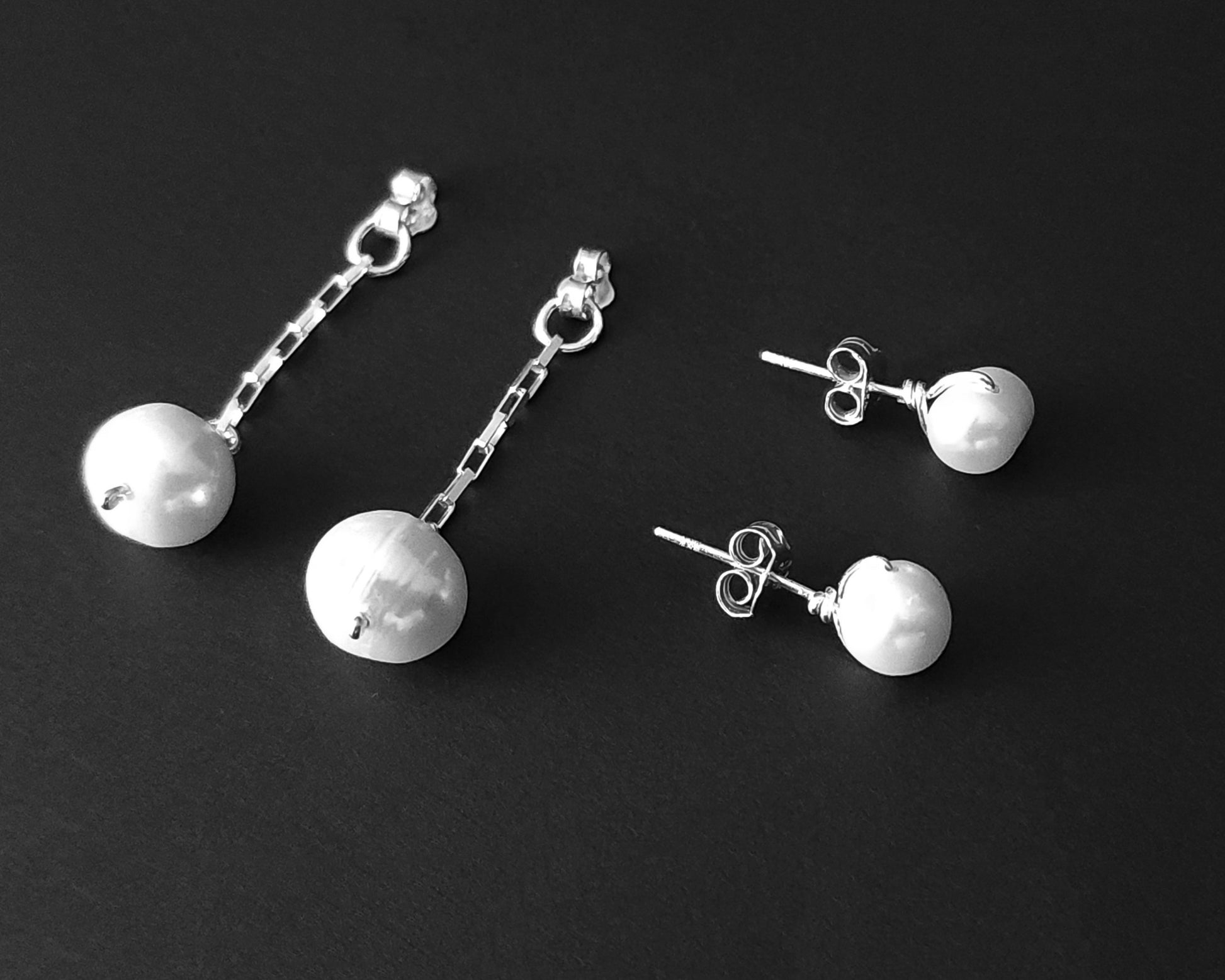 Convertible Sterling Silver Freshwater Cultured Peal Dangle and Post Earrings with Large pearls on the end of a long chain on black background 