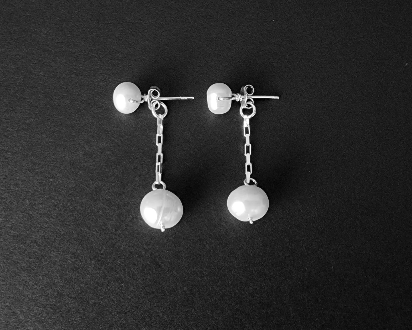 Convertible Sterling Silver Freshwater Cultured Peal Dangle and Post Earrings with Large pearls on the end of a long chain on black background 
