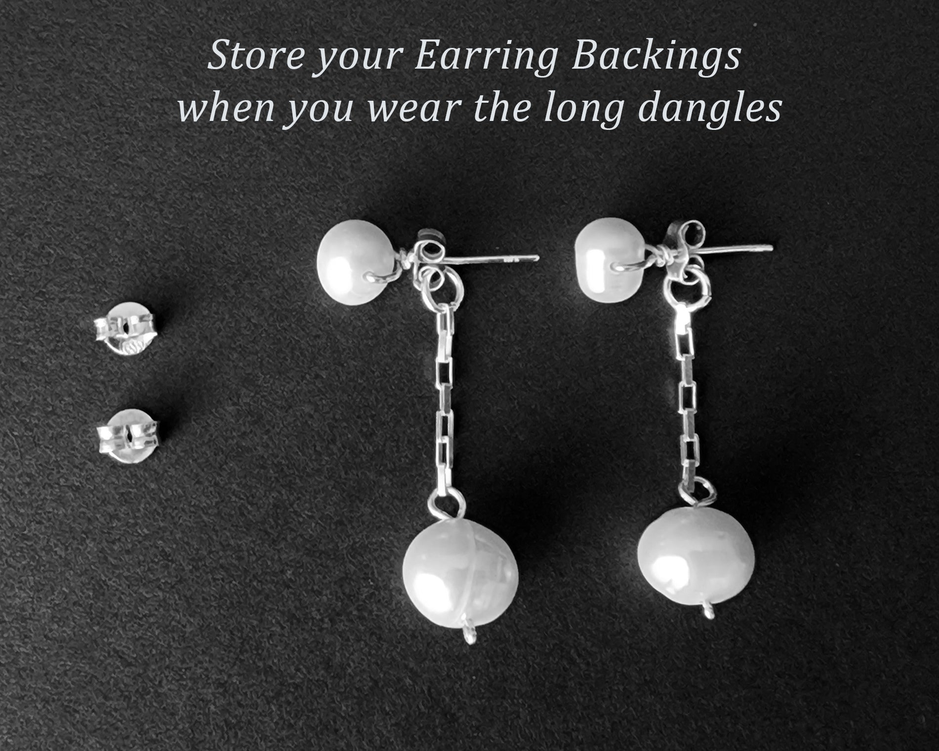 Convertible Sterling Silver Freshwater Cultured Peal Dangle and Post Earrings with Large pearls on the end of a long chain on black background 