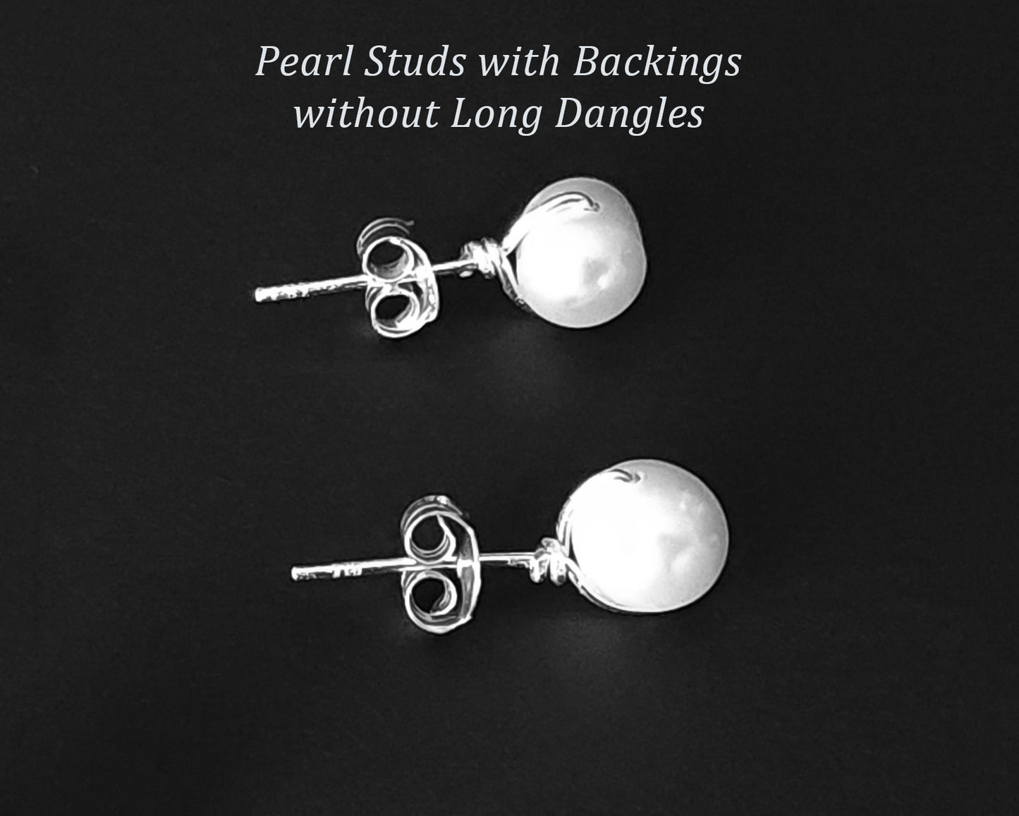 White Pearl Stud Earrings on black background 