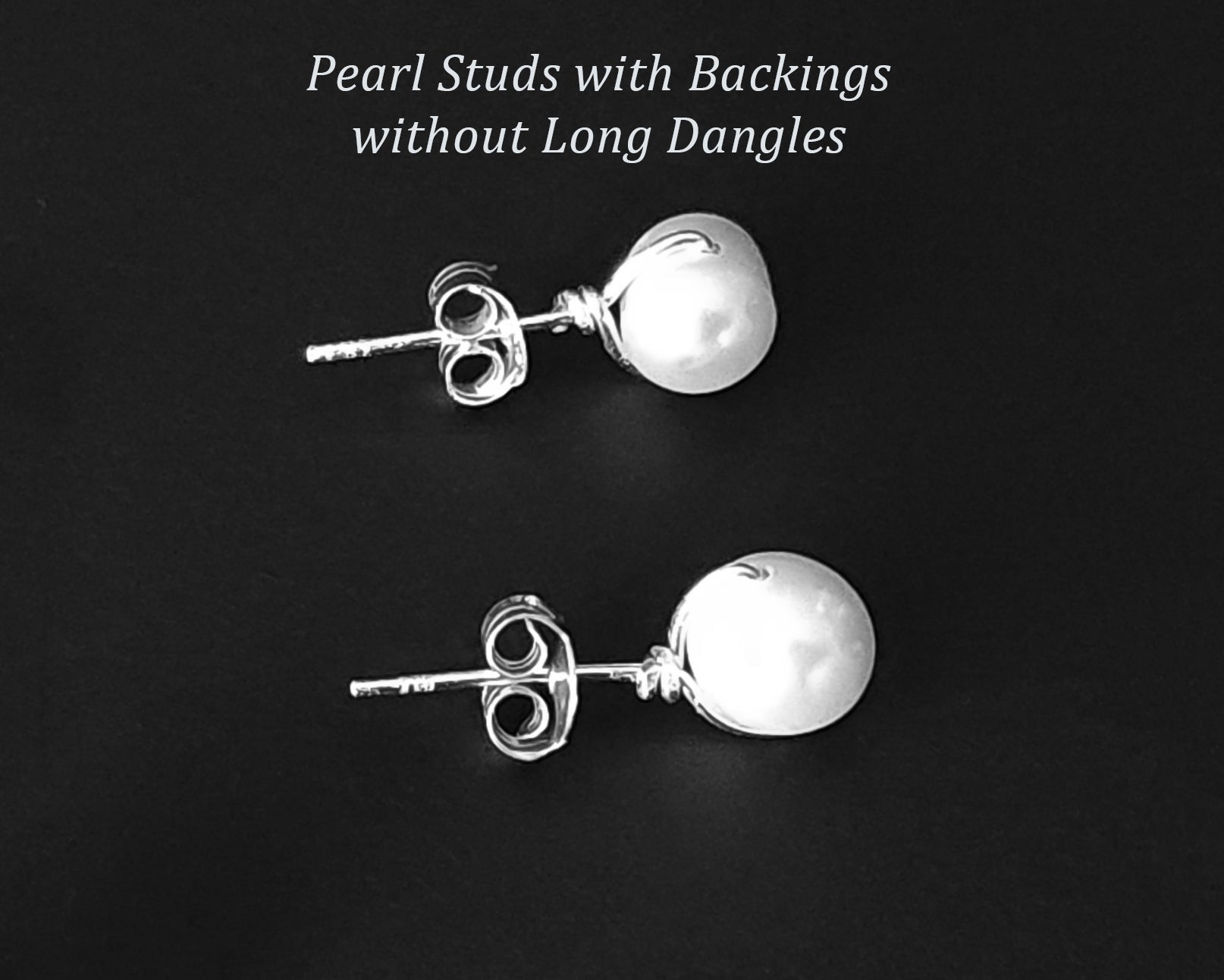 White Pearl Stud Earrings on black background 