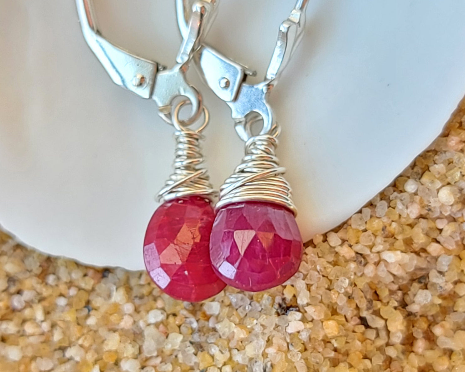 Faceted Ruby Drop Dangle Earrings with briolette wrapped drop shape red Ruby stones, dangling from lever back earring hooks.