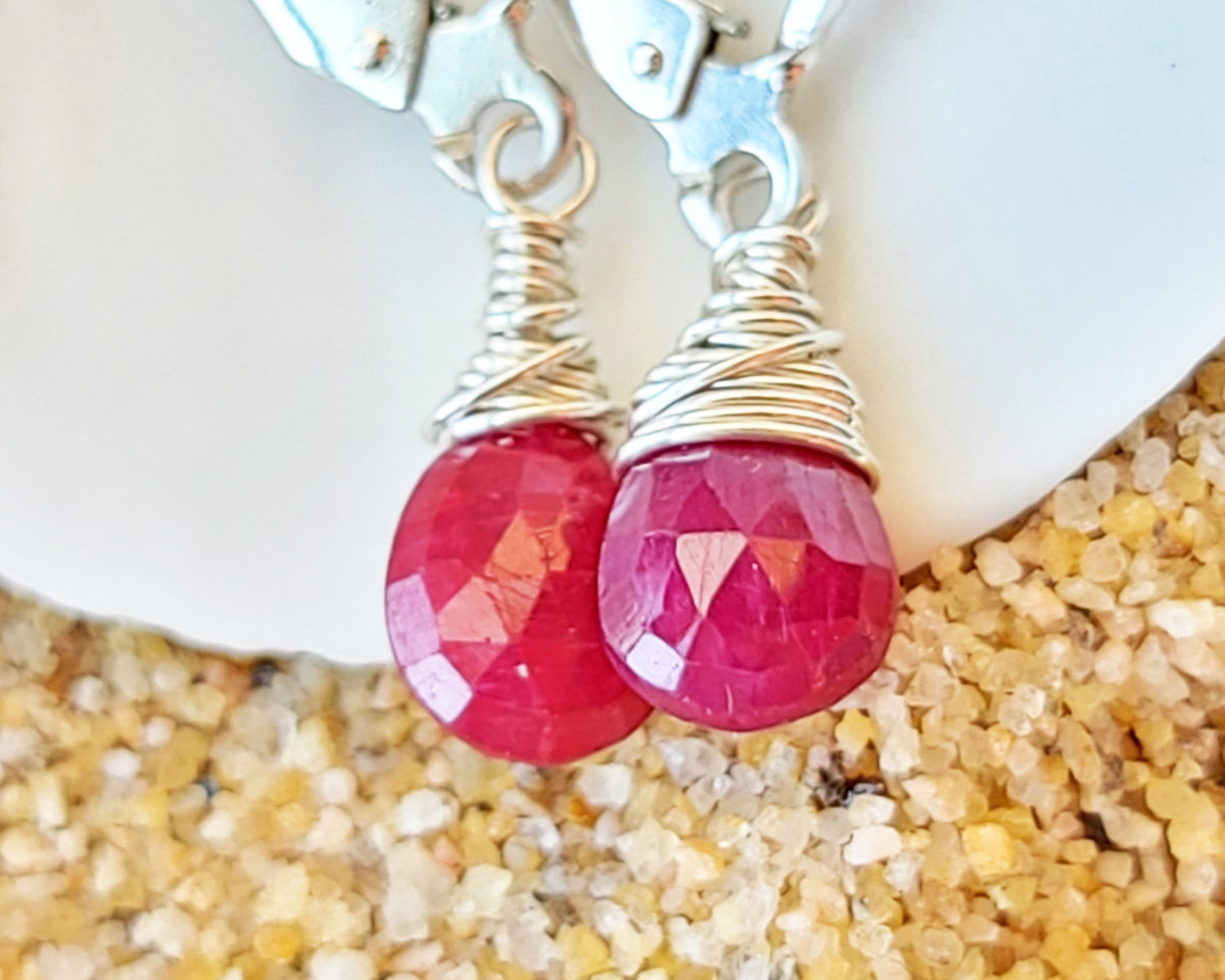 Faceted Ruby Drop Dangle Earrings with briolette wrapped drop shape red Ruby stones, dangling from lever back earring hooks.