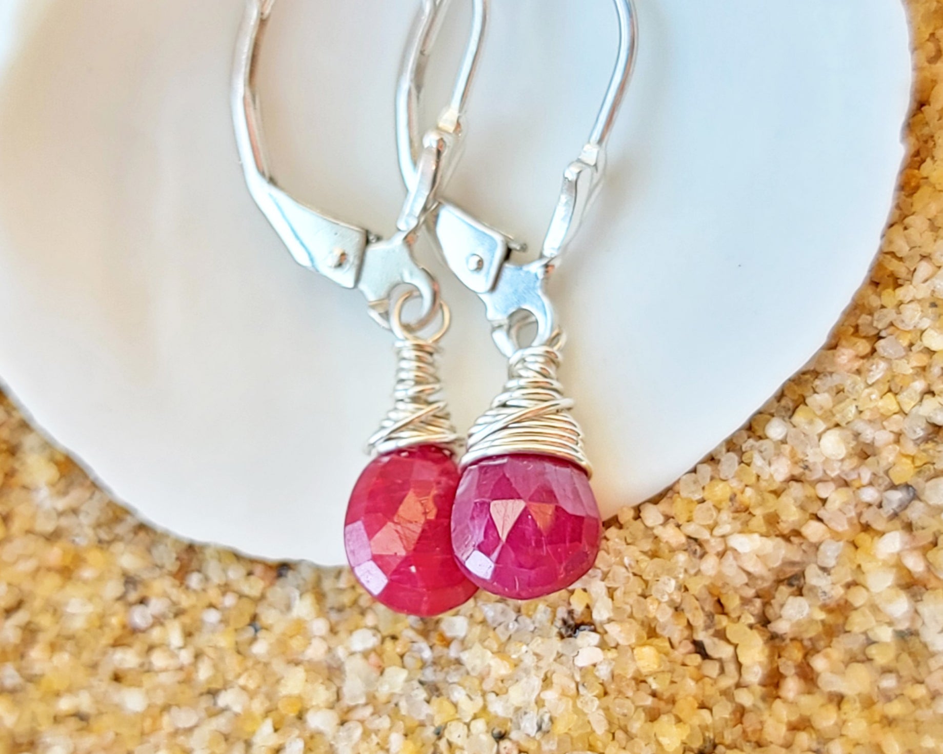 Faceted Ruby Drop Dangle Earrings with briolette wrapped drop shape red Ruby stones, dangling from lever back earring hooks.