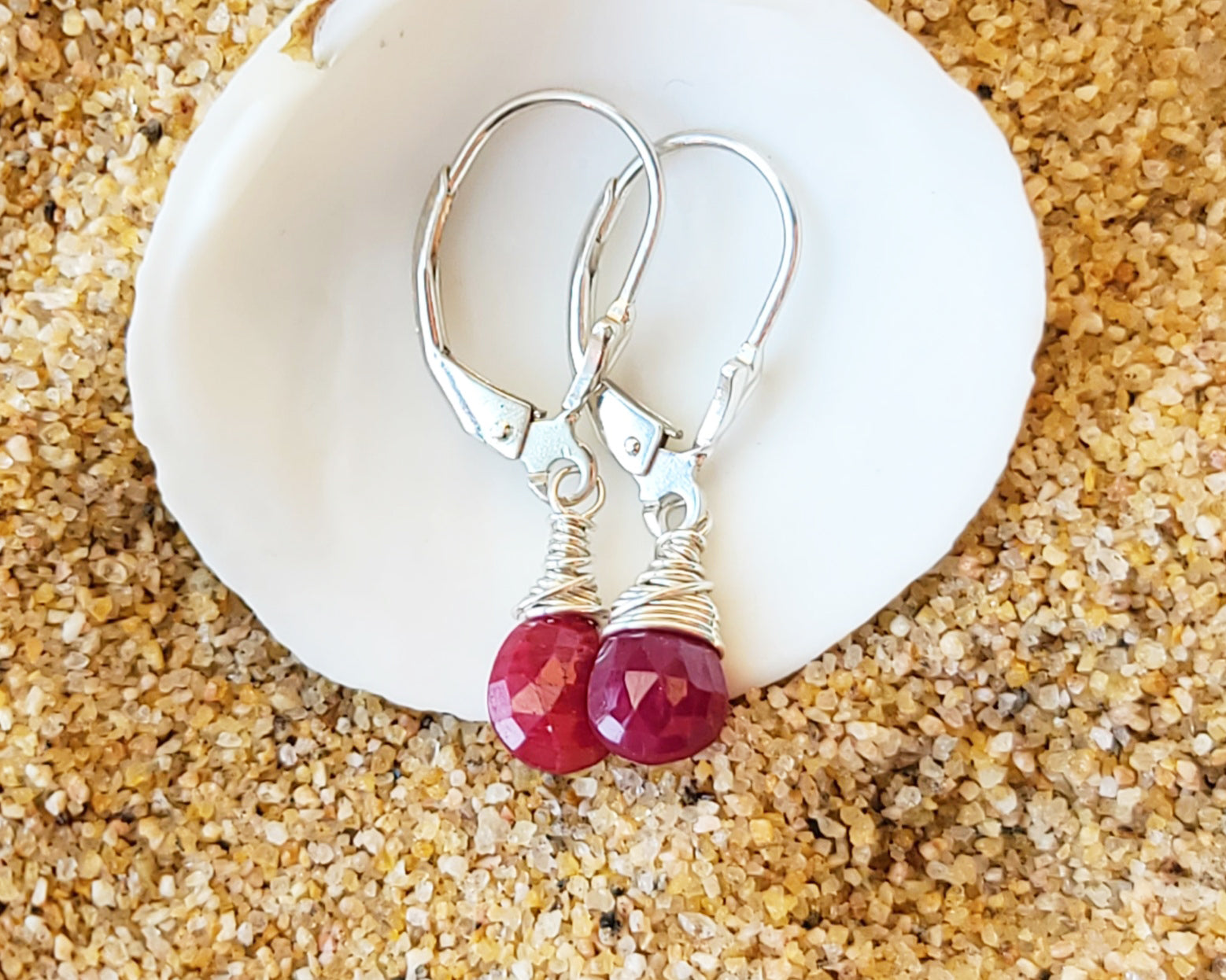 Faceted Ruby Drop Dangle Earrings with briolette wrapped drop shape red Ruby stones, dangling from lever back earring hooks.