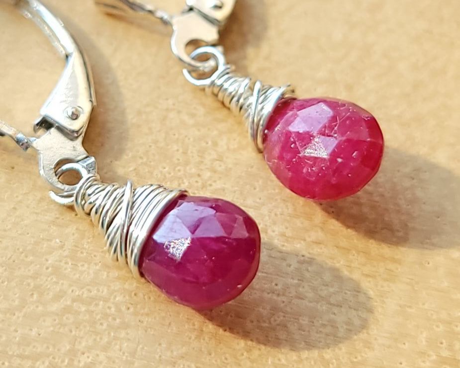 Faceted Ruby Drop Dangle Earrings with briolette wrapped drop shape red Ruby stones, dangling from lever back earring hooks.