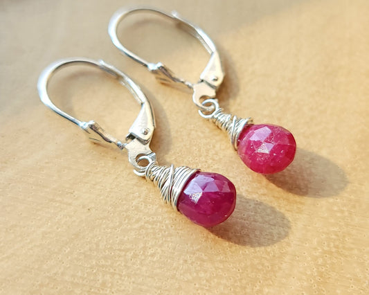 Faceted Ruby Drop Dangle Earrings with briolette wrapped drop shape red Ruby stones, dangling from lever back earring hooks.