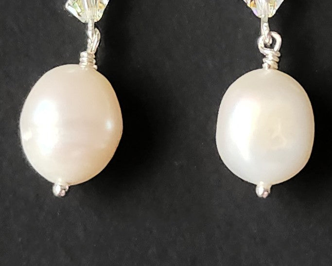 White pearl clear AB Crystal threader dangle style earrings Silver french hooks with three clear AB crystals and large white pearl dangles on black background
