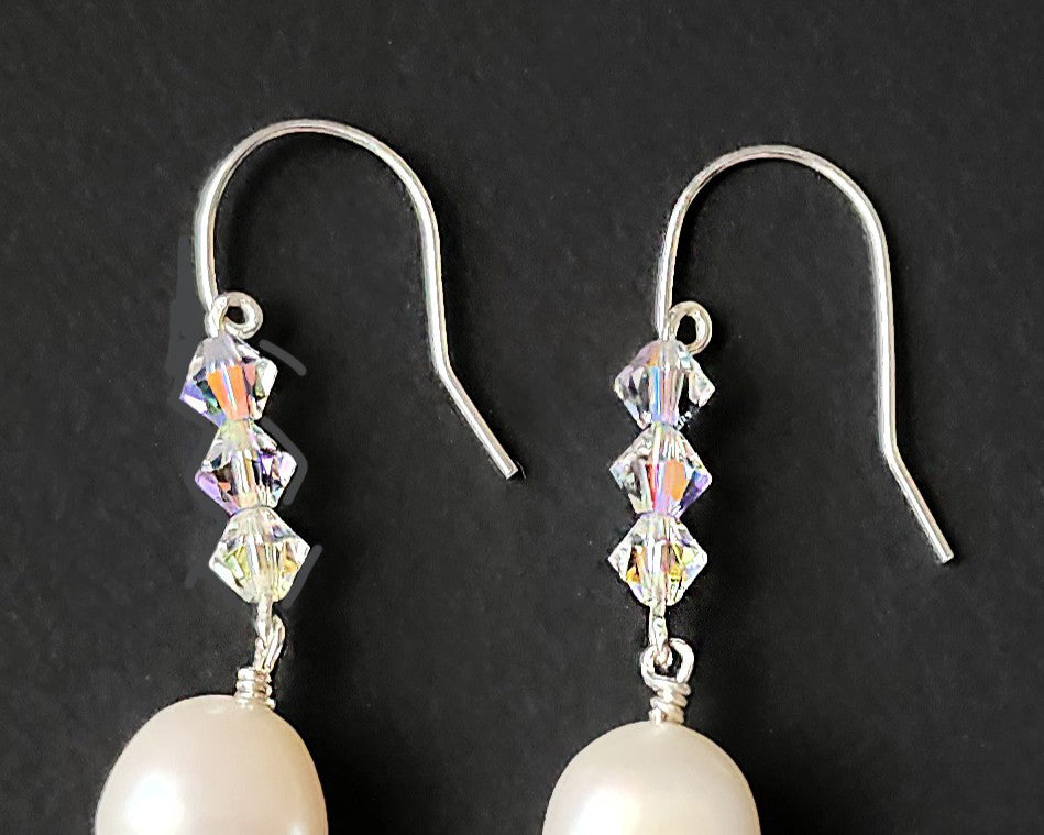 White pearl clear AB Crystal threader dangle style earrings Silver french hooks with three clear AB crystals and large white pearl dangles on black background