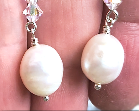 White pearl clear AB Crystal threader dangle style earrings with three clear AB crystals and large white pearl dangles on hand 