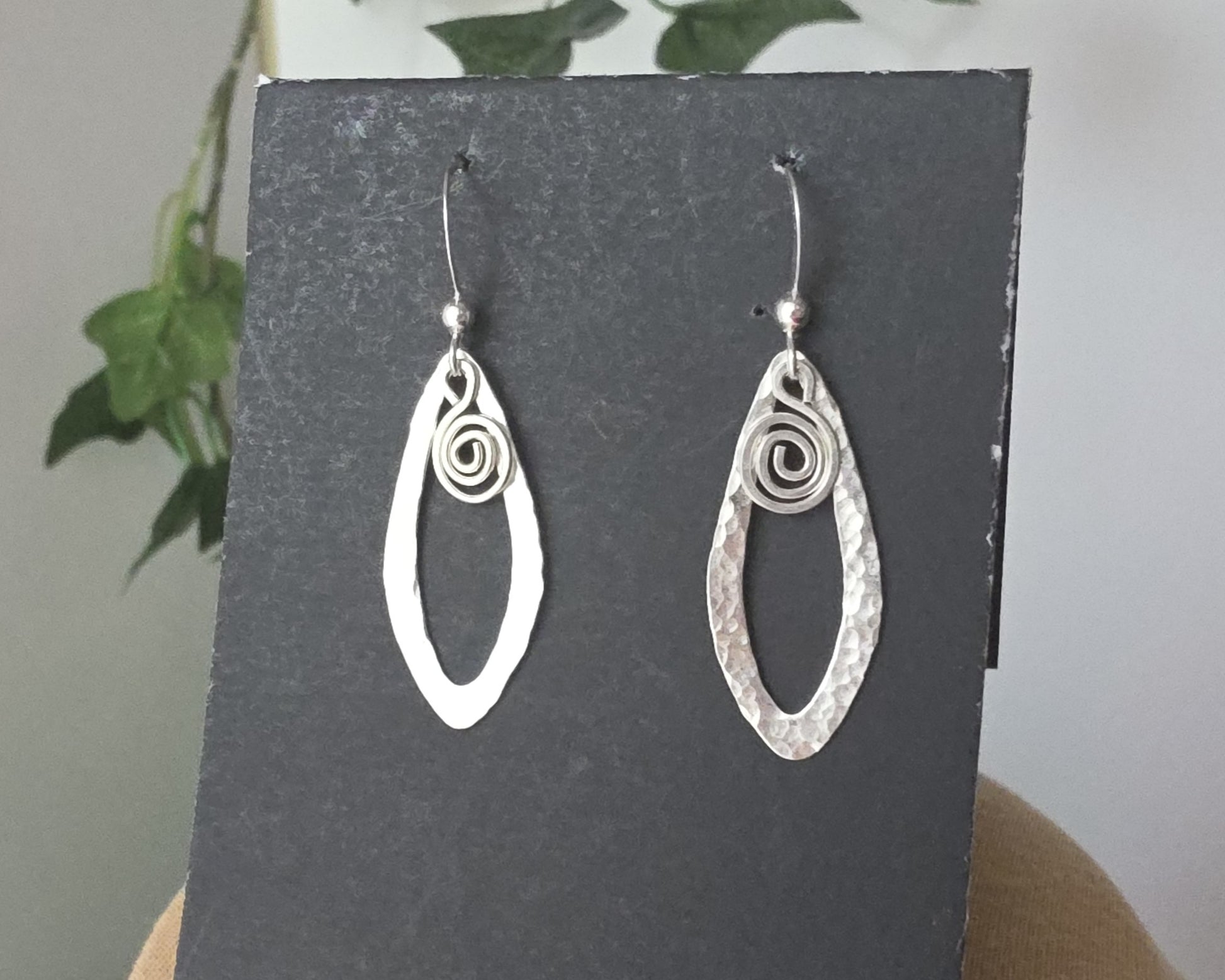 Sterling Silver, long Celtic style Dragonfly Wing earrings with dangling Eternity Coils on French style earring hooks on black background