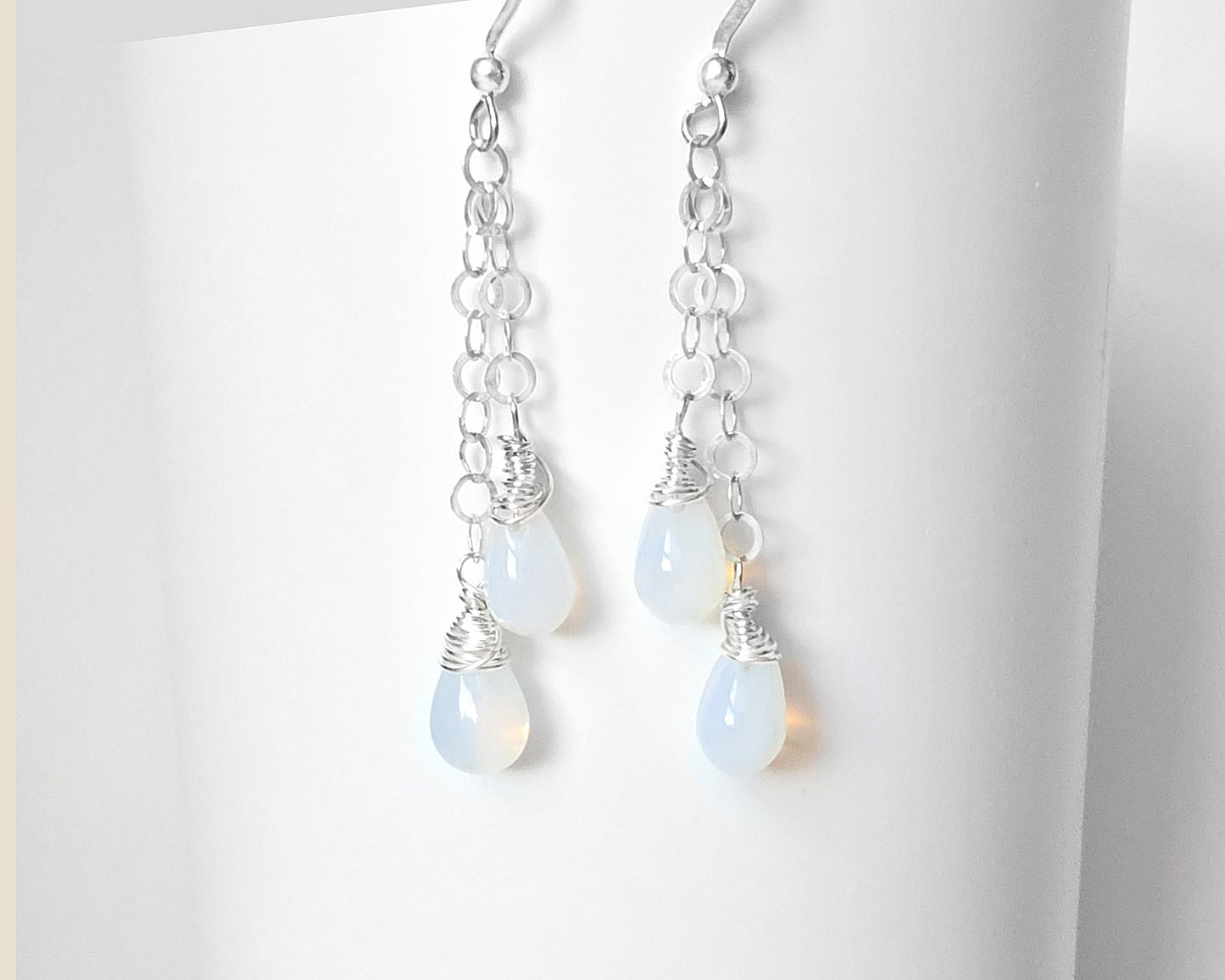 Long Sterling Silver double chain earrings with Opalite drops wrapped with Sterling Silver wire with French earring hooks on white background