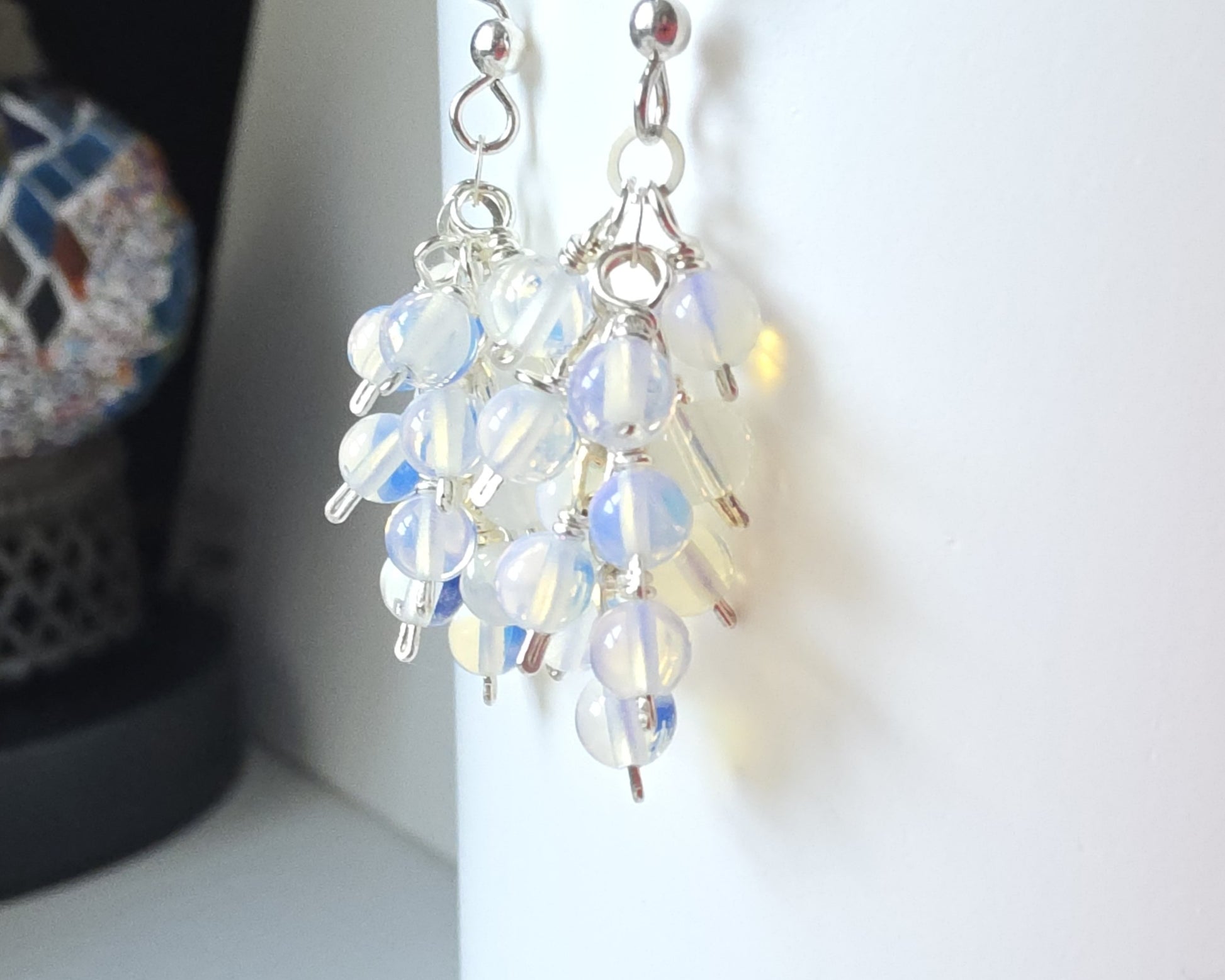 Sterling Silver Opalite Cluster earrings with blue gold stones on French earring hooks on white background 