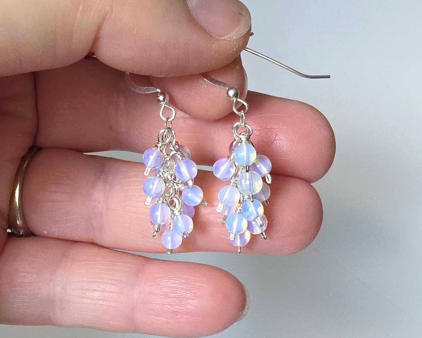 Sterling Silver Opalite Cluster earrings with blue gold stones on french earring hooks on hand 